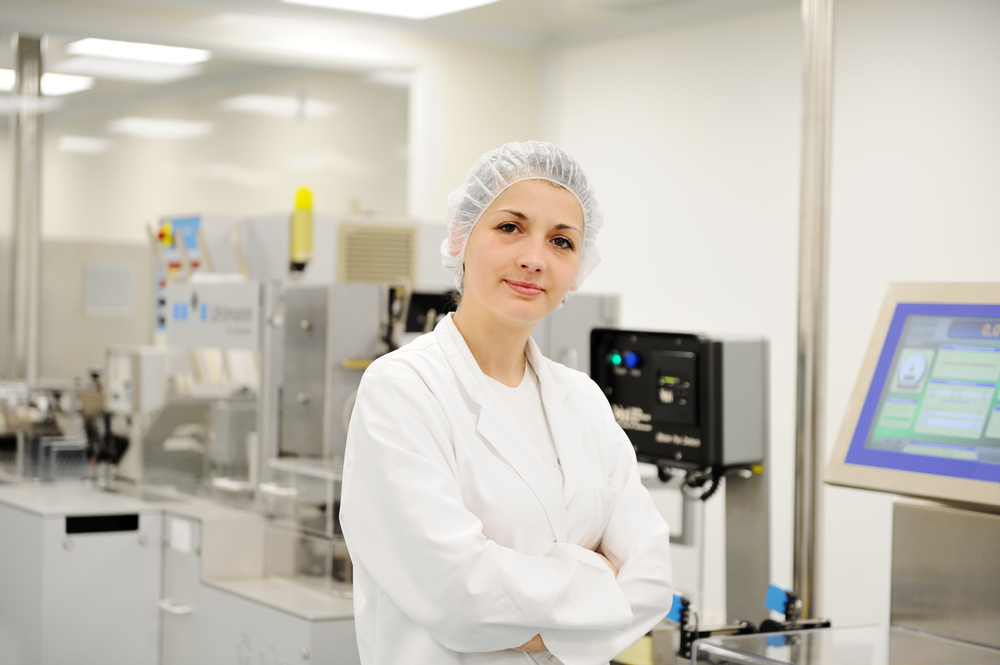 Working woman at automated production line in modern factory